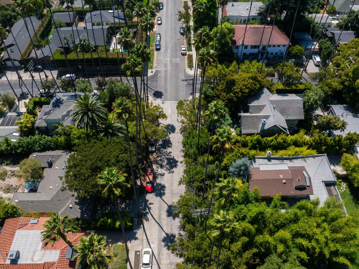 A quiet residential street with palm trees and vacation rental properties in San Diego, California
