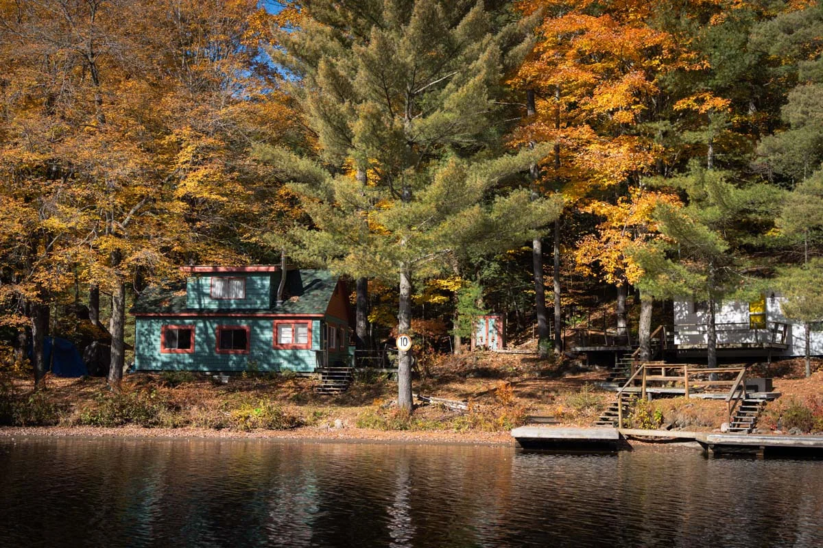A waterfront cottage rental in a popular Muskoka Airbnb area during a sunny summer day