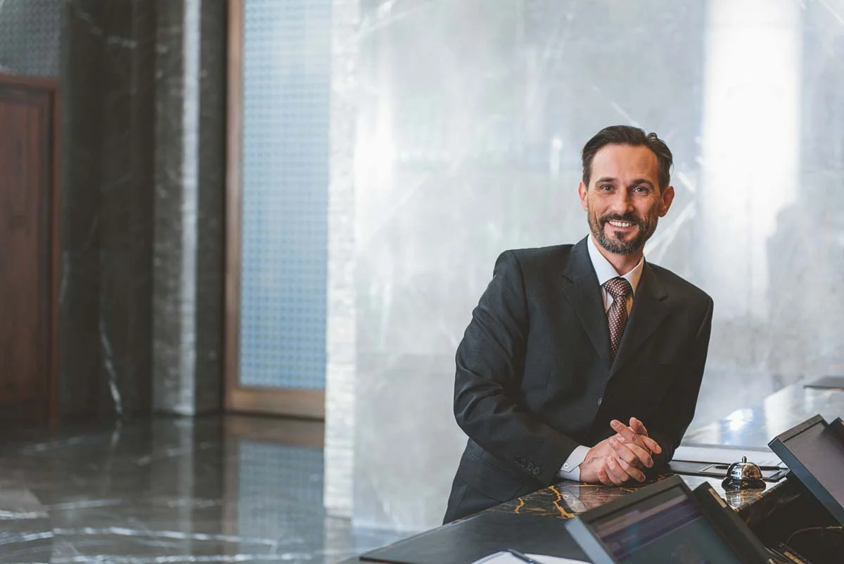 Property owner in a modern lobby and reception area of a clean aparthotel