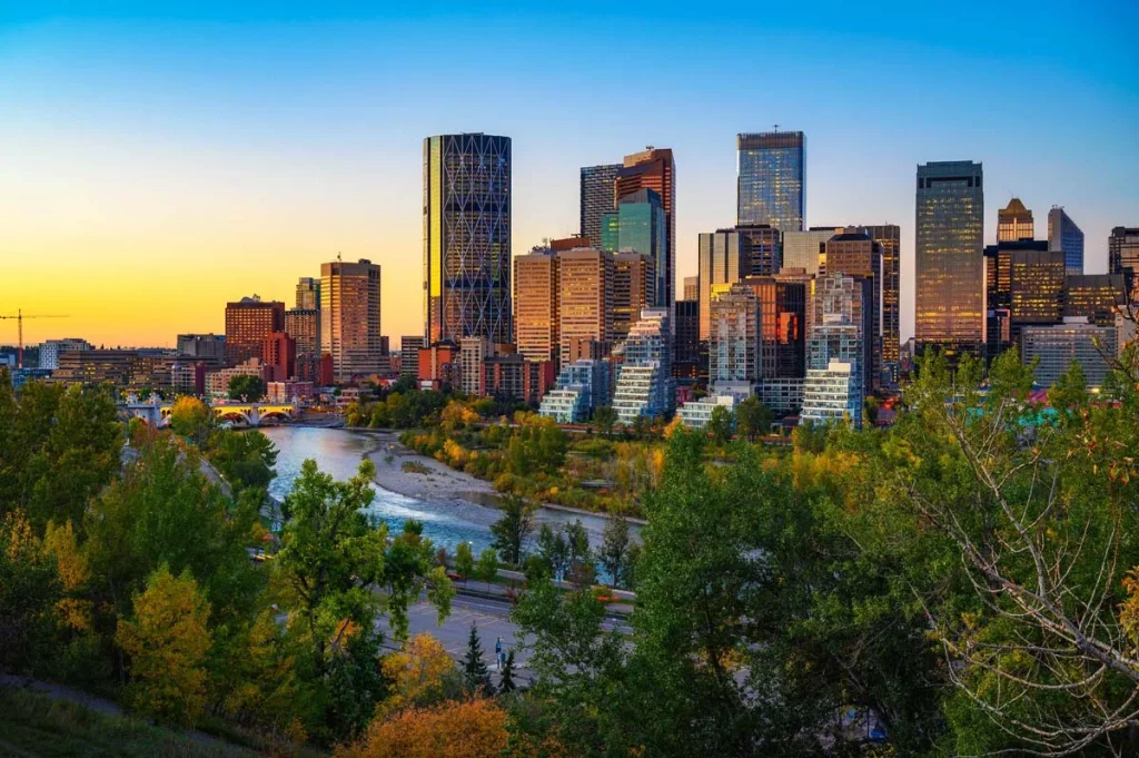 Scenic view of the Bow River flowing past downtown Calgary, Alberta, highlighting urban nature and tourism appeal