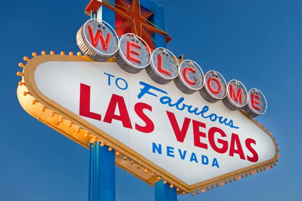 The iconic Welcome to Fabulous Las Vegas sign under a bright blue sky representing Airbnb neighborhoods in Las Vegas