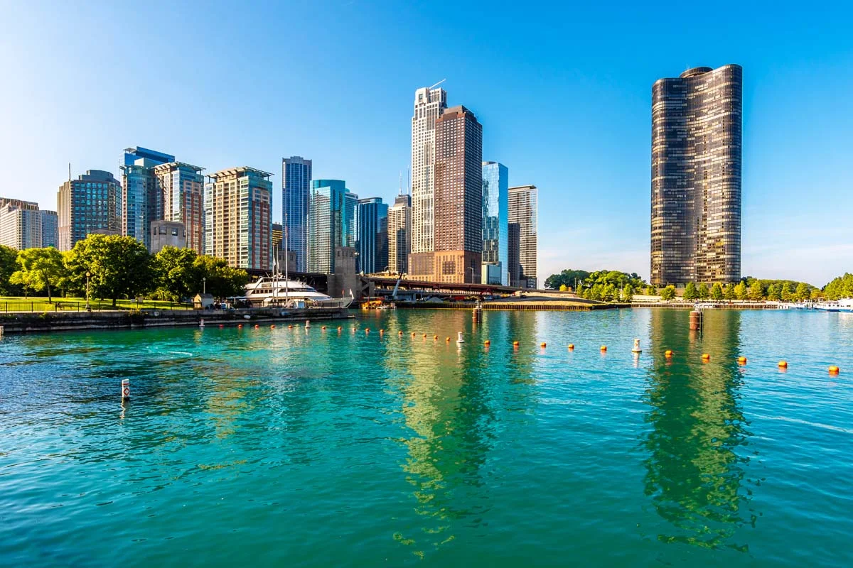 Wide-angle view of the Chicago skyline and Lake Michigan during sunset to represent short term rentals in Chicago