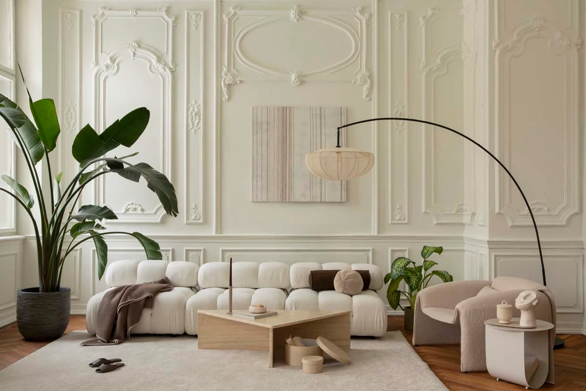 A clean and modern living room interior with cozy furniture and bright natural light