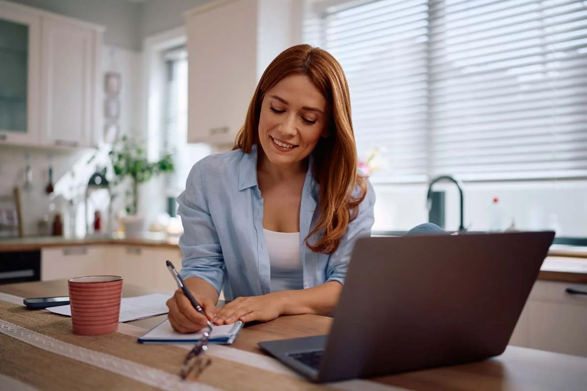 A homeowner using a laptop to research a Mississauga short term rental license