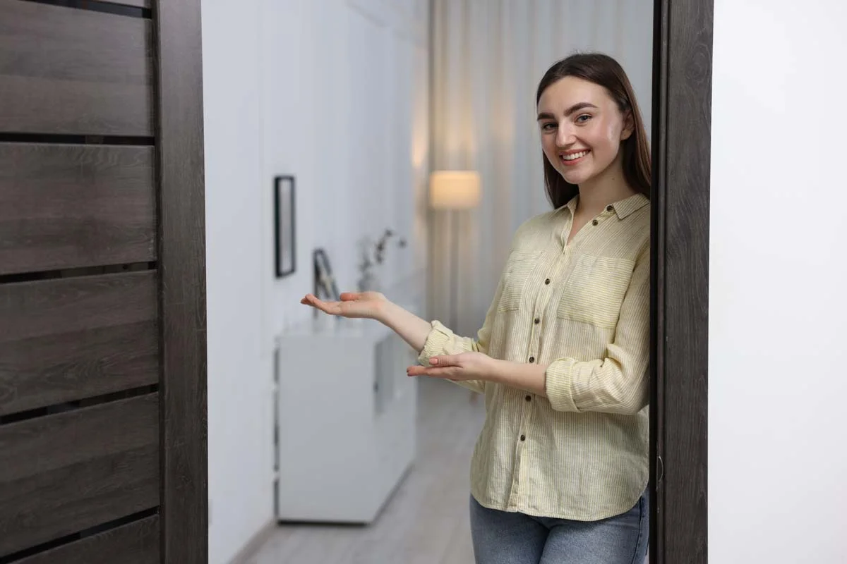 A host welcoming new short term rental guests in their home