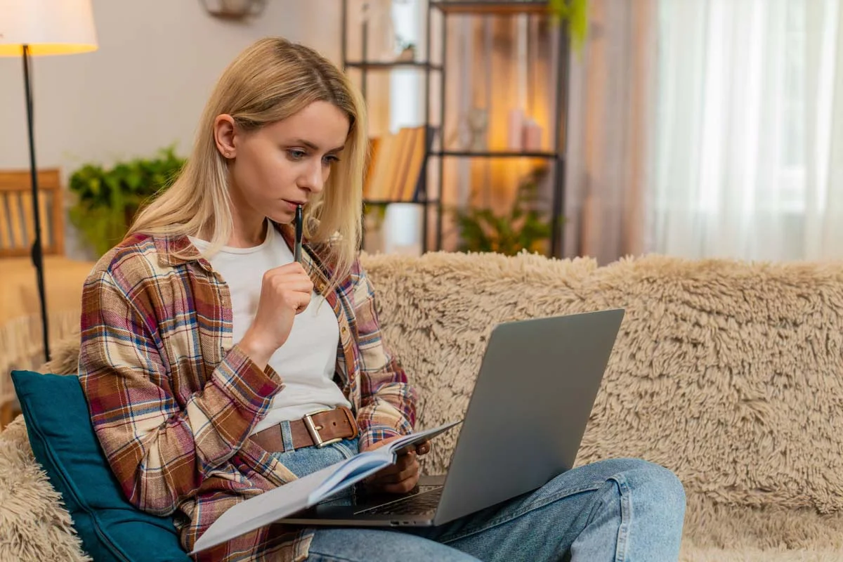 A person at home applying for a short term rental license on their laptop