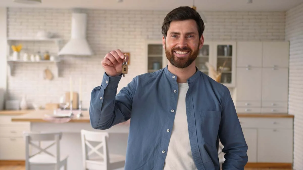 A property owner holding keys for a Hamilton short term rental.