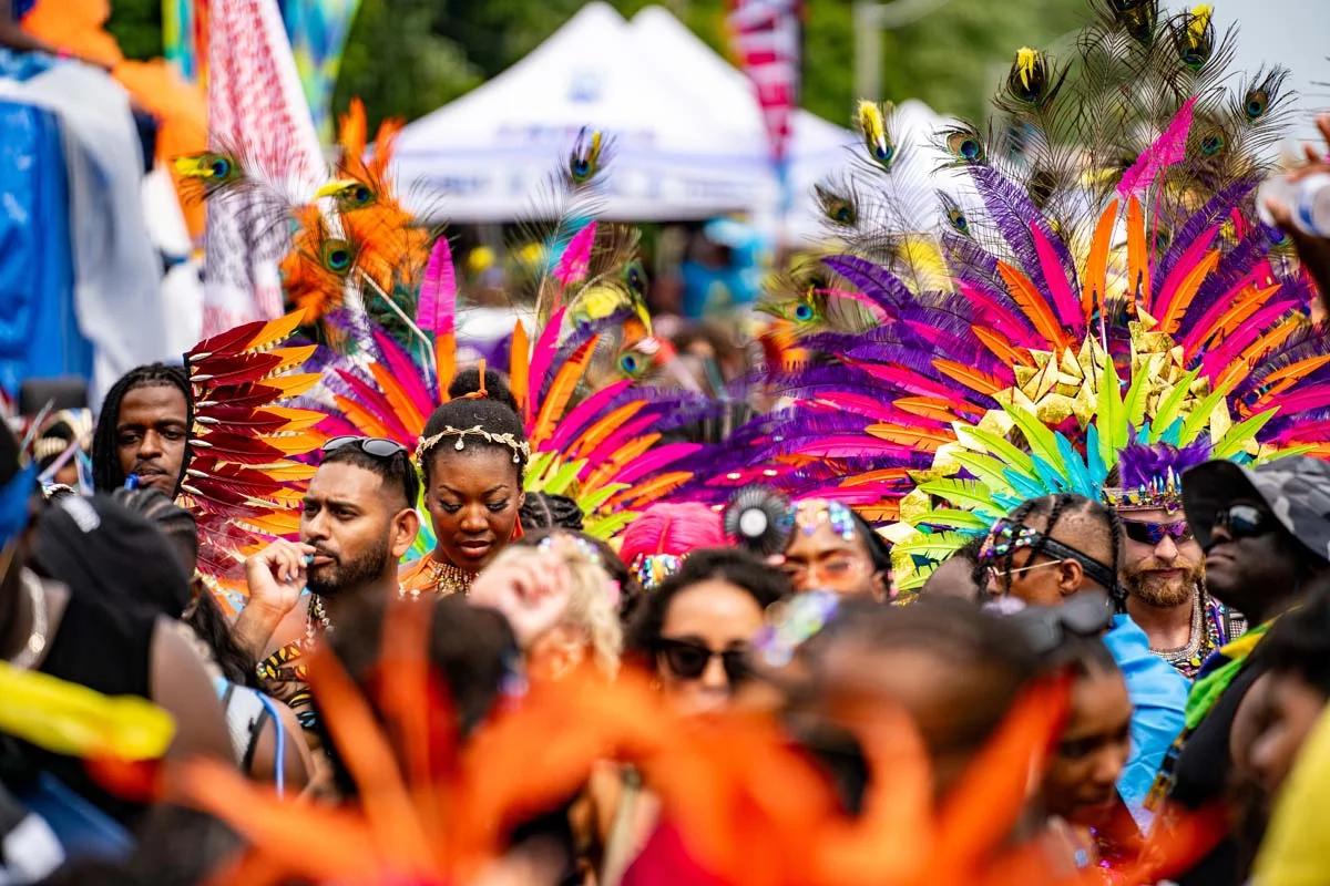 Colorful parade performers and a large crowd celebrating at the Caribana Festival Toronto