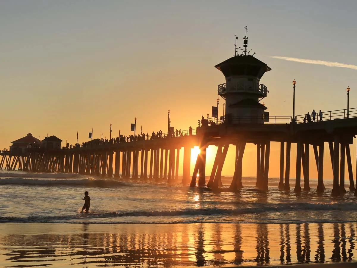 Sunset view of the Huntington Beach Pier and Pacific Ocean waves in California