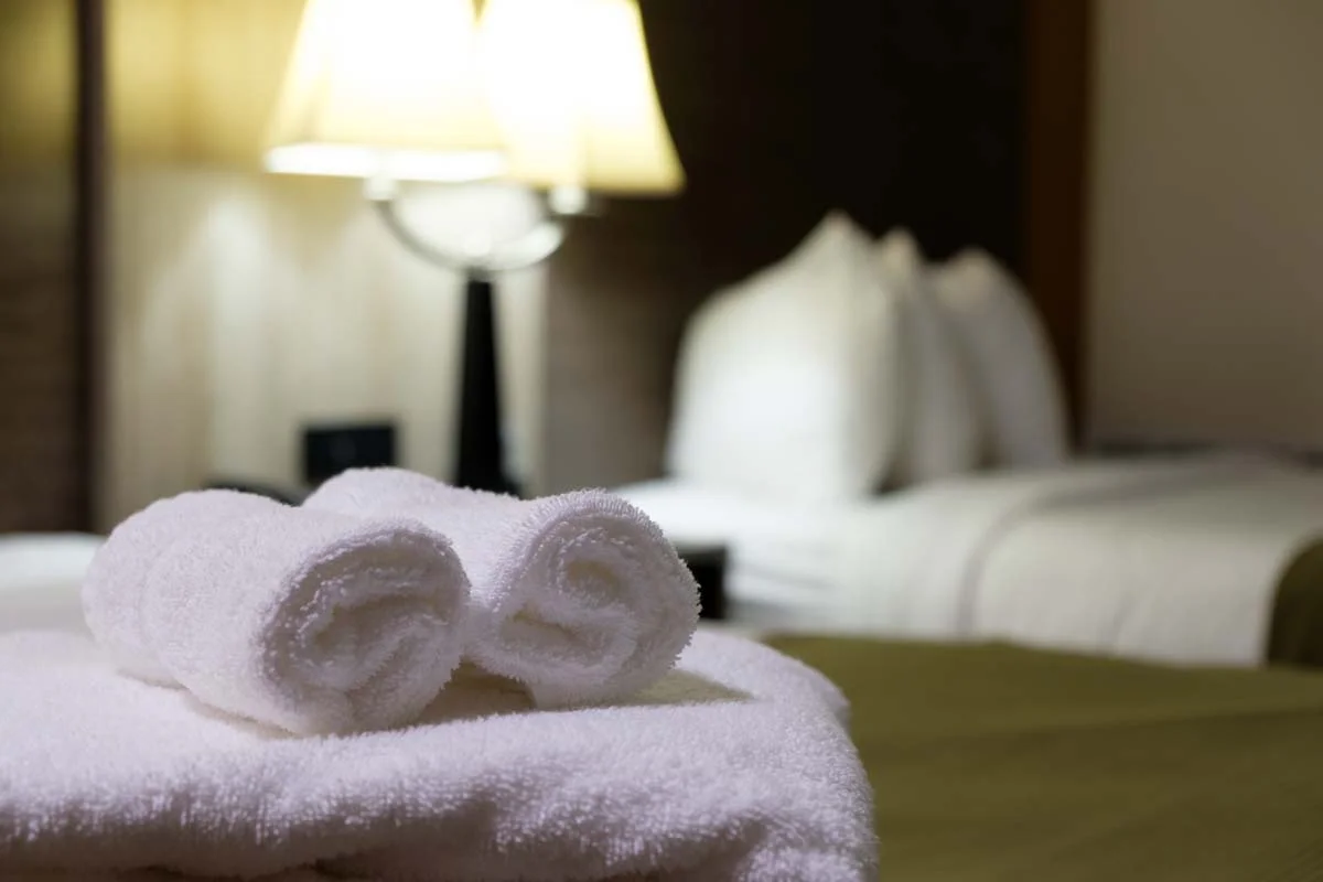 A clean guest room with fresh linens prepared for a short-term stay