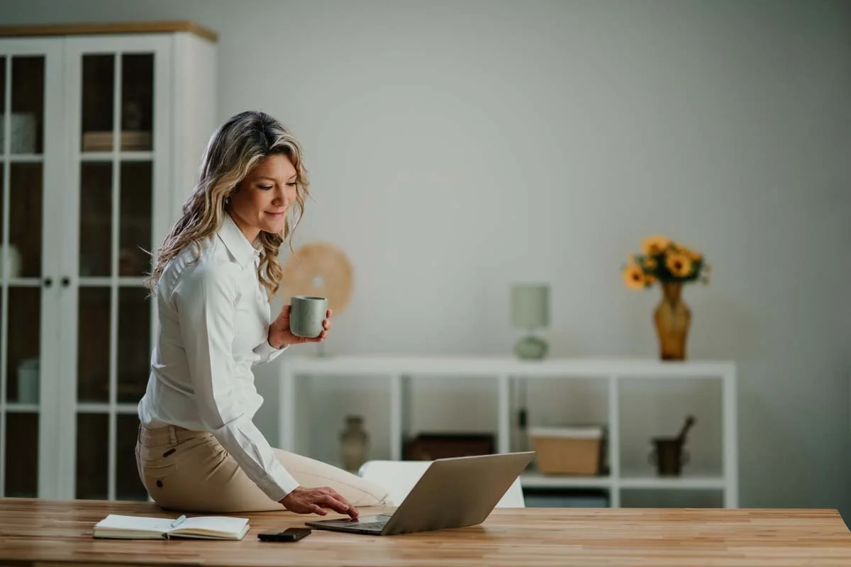 A corporate traveler working from a laptop in a comfortable extended-stay residential rental home