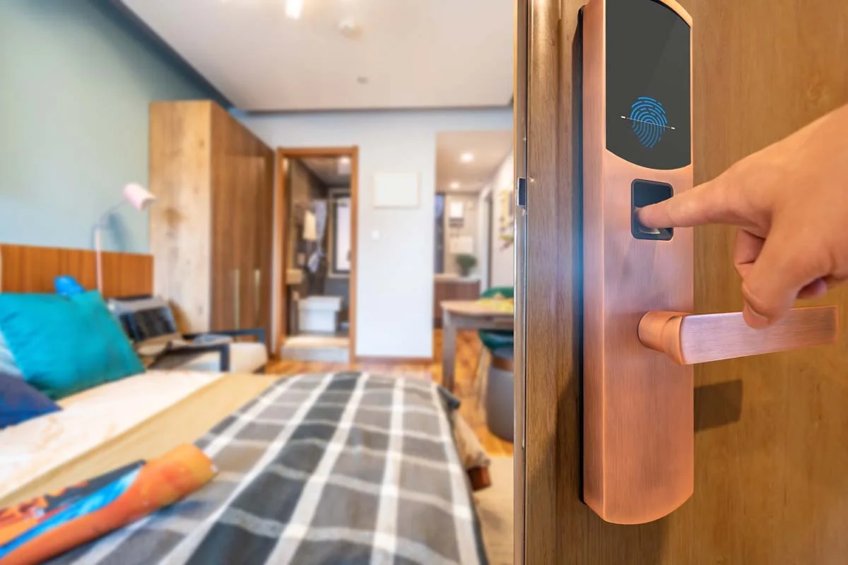 A guest using a smart Wi-Fi door lock to enter a short-term rental property