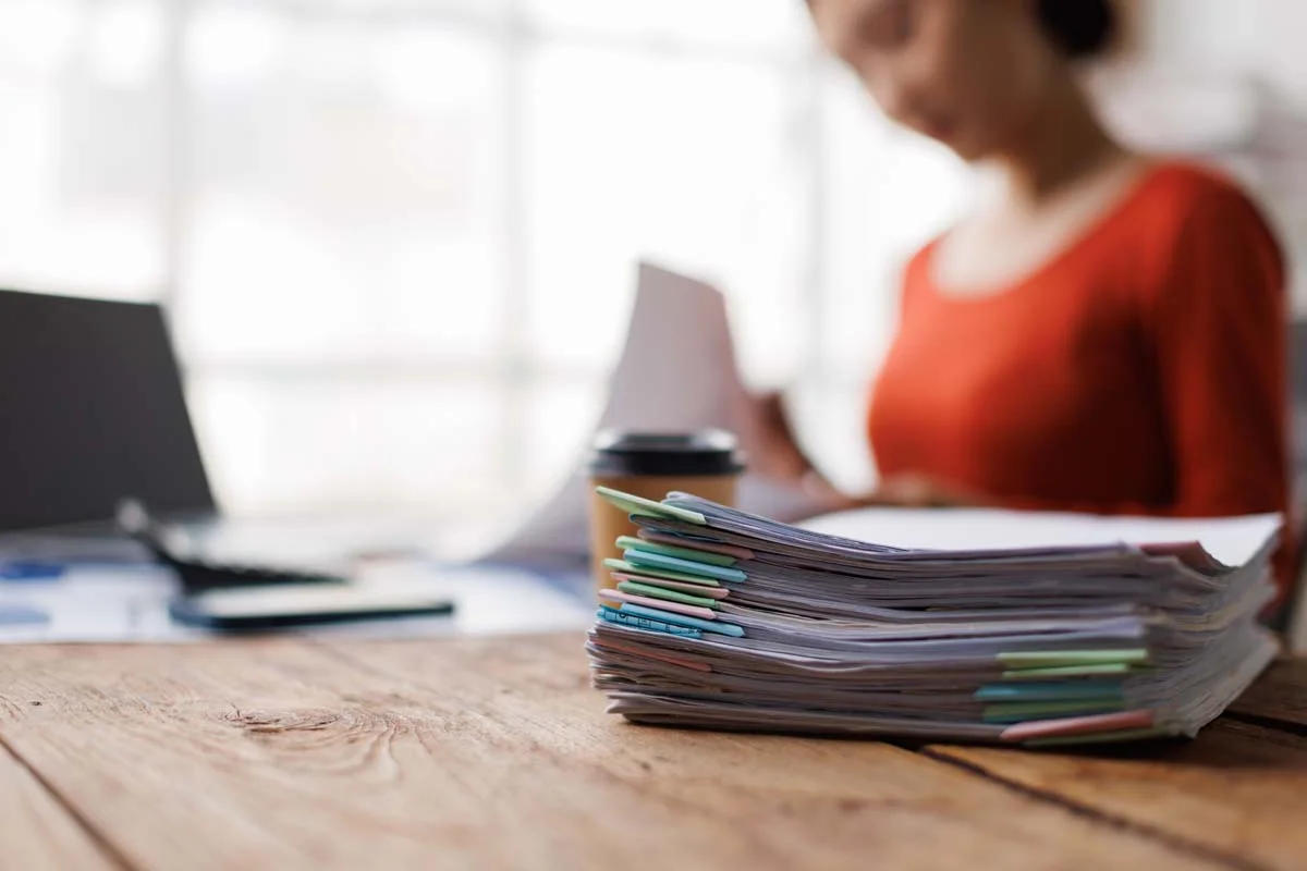 A homeowner organizing documents for a short-term rental license application