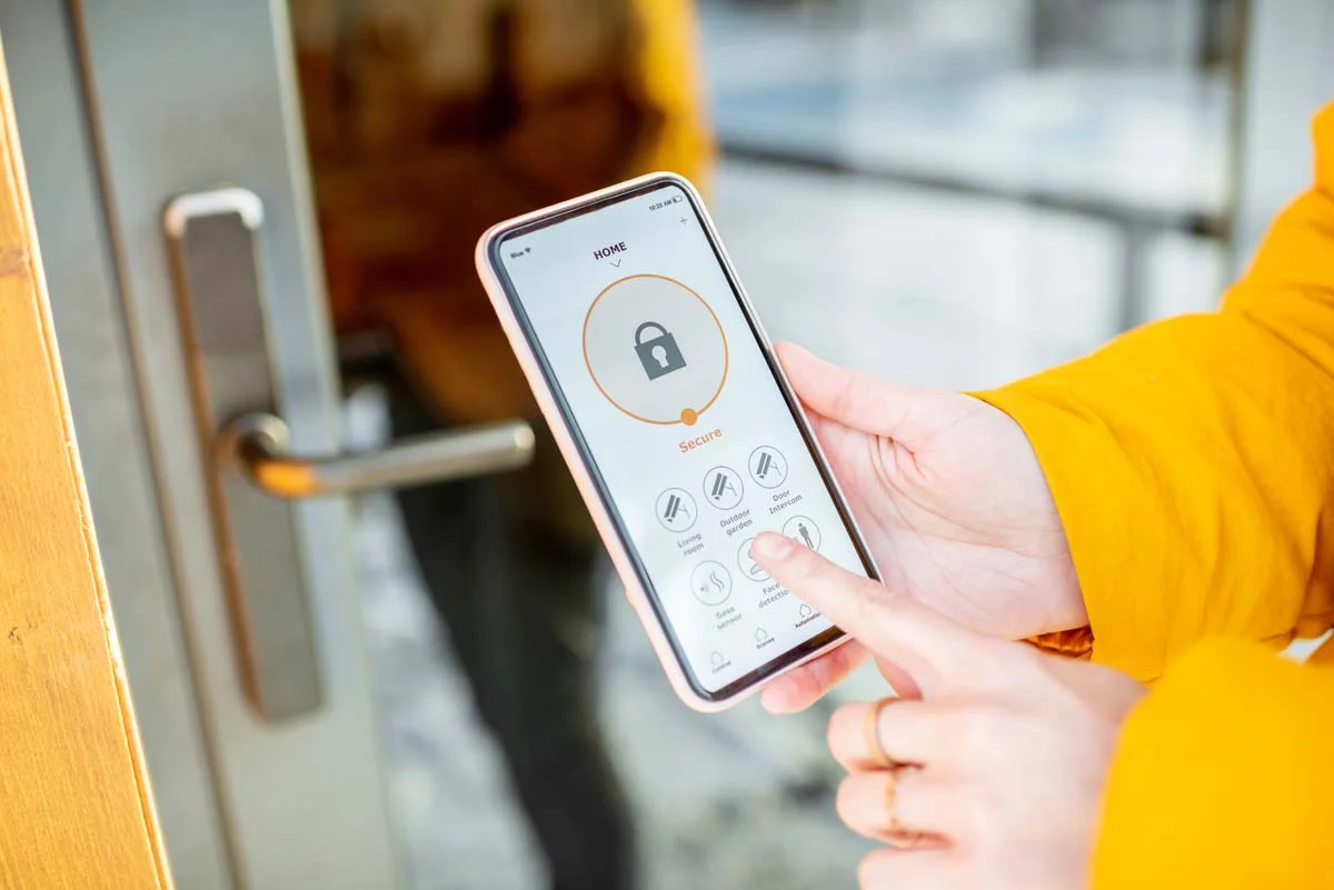 A modern smart lock on a residential front door used to streamline guest communication and uphold community standards
