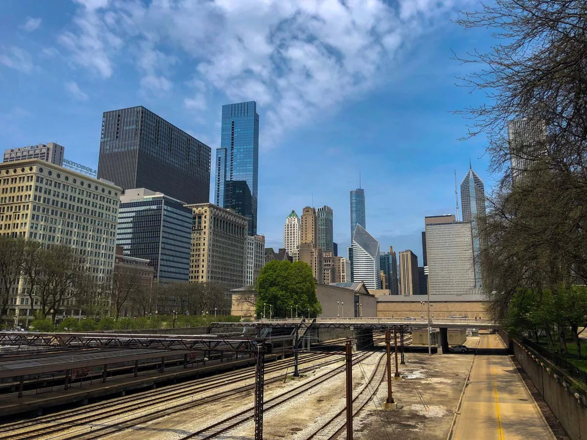 A scenic view of the Chicago railroad with tall buildings in the background