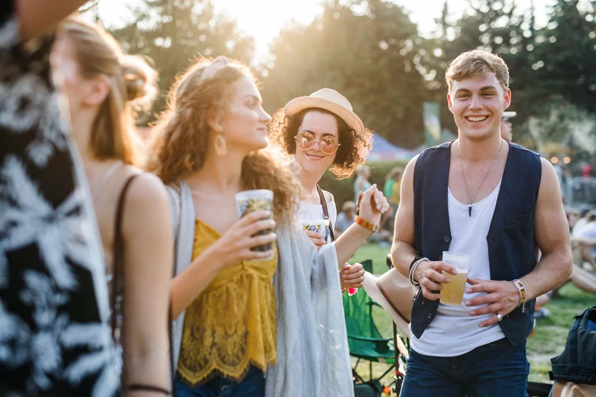 A vibrant crowd of people enjoying an outdoor summer street festival