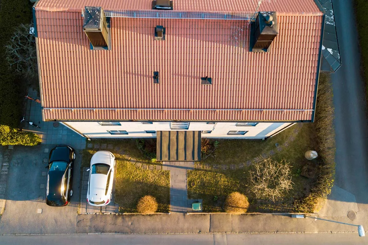 Car parked neatly in the driveway of a rural country home