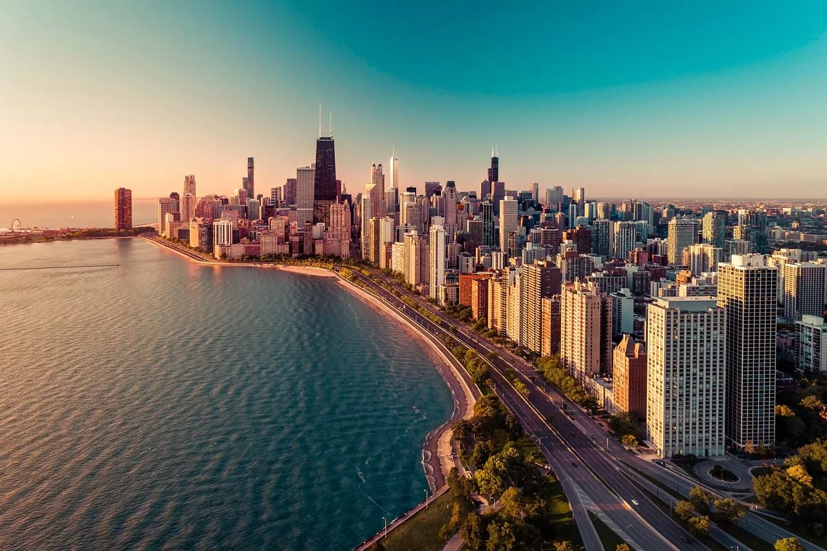 Chicago skyline aerial view with sunrise above downtown buildings and Lake Michigan