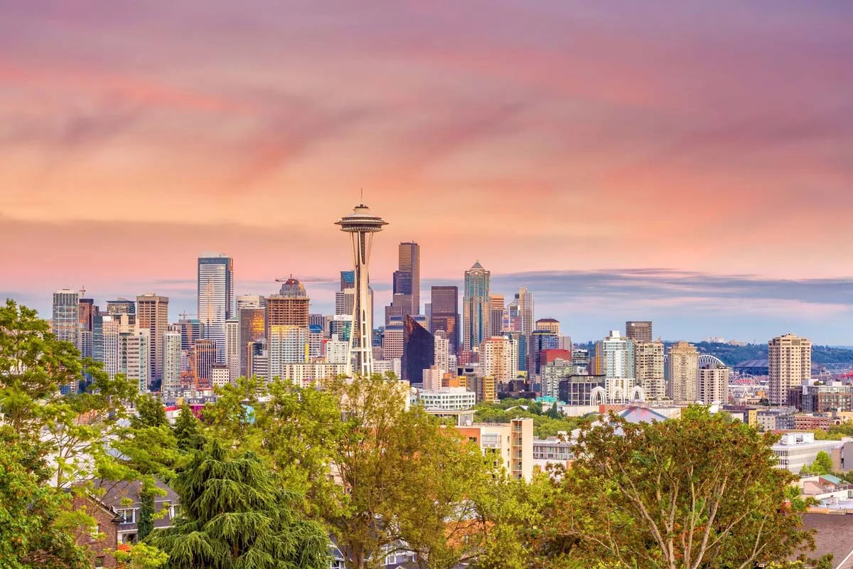 The Seattle city skyline at sunset featuring the Space Needle and urban waterfront buildings