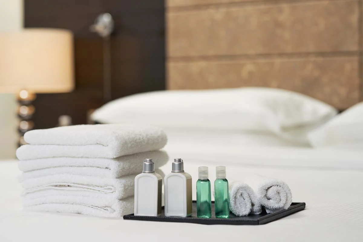 Close-up of luxury hospitality amenities and fresh linens in a short-term rental