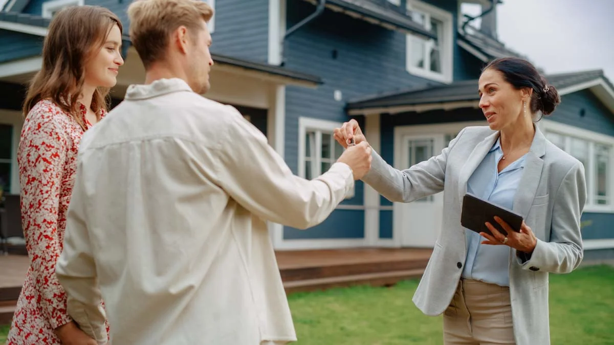 Professional property manager giving guests the key to a rental home