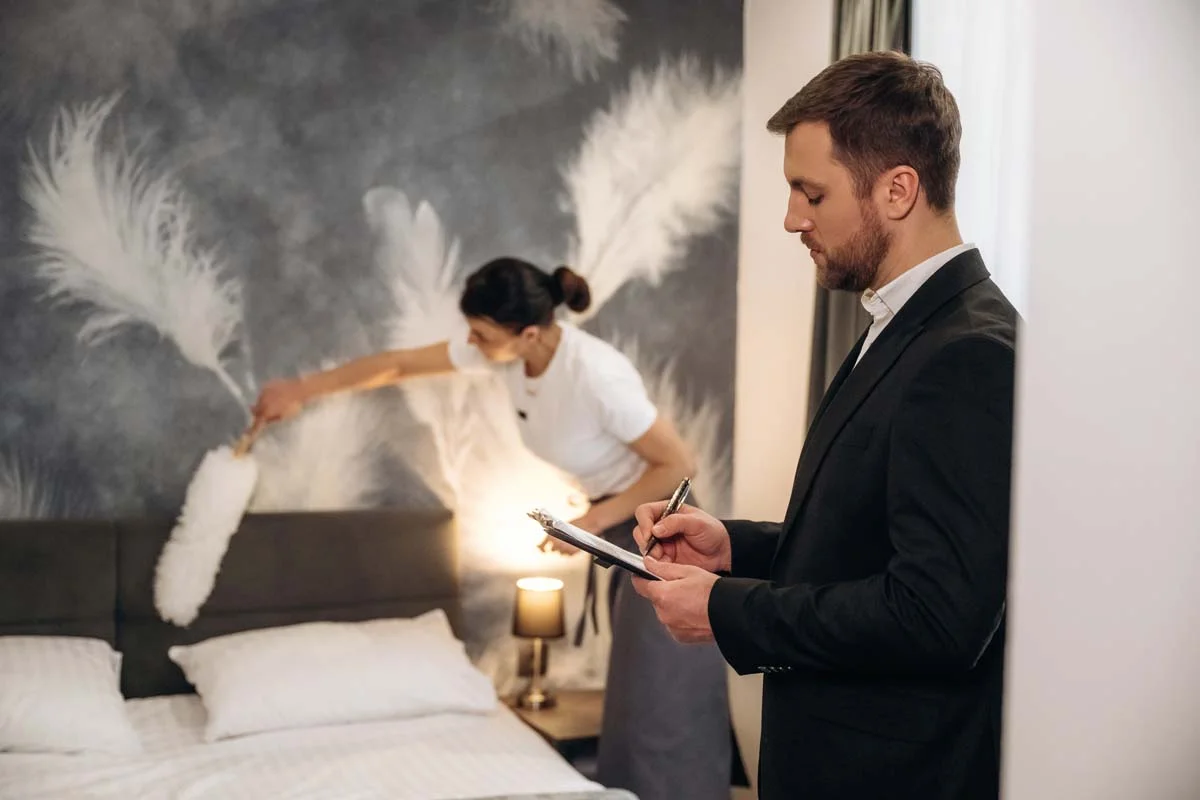Property manager inspecting a clean and bright vacation rental bedroom