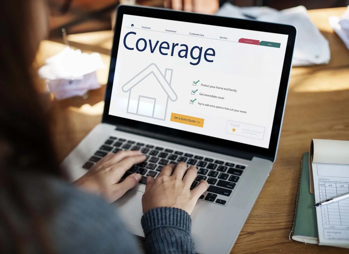 Property owner comparing short term rental insurance quotes on a laptop