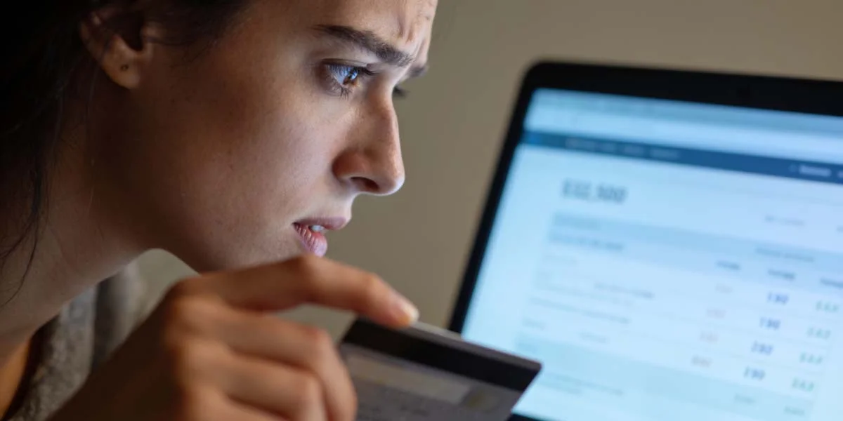 Stressed traveler looking at a laptop while trying to resolve booking problems
