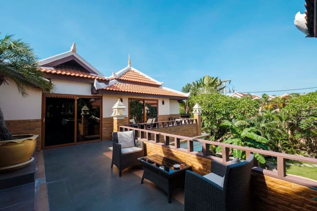 A beautiful modern vacation rental home with a sunlit deck, showcasing high-end exterior property features for short-term rental listings