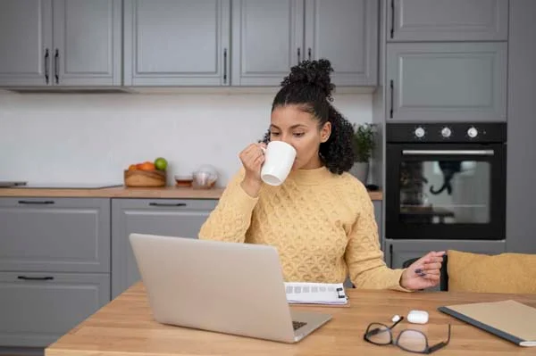 A relaxed homeowner reviewing a clear digital financial statement on a laptop screen while working remotely