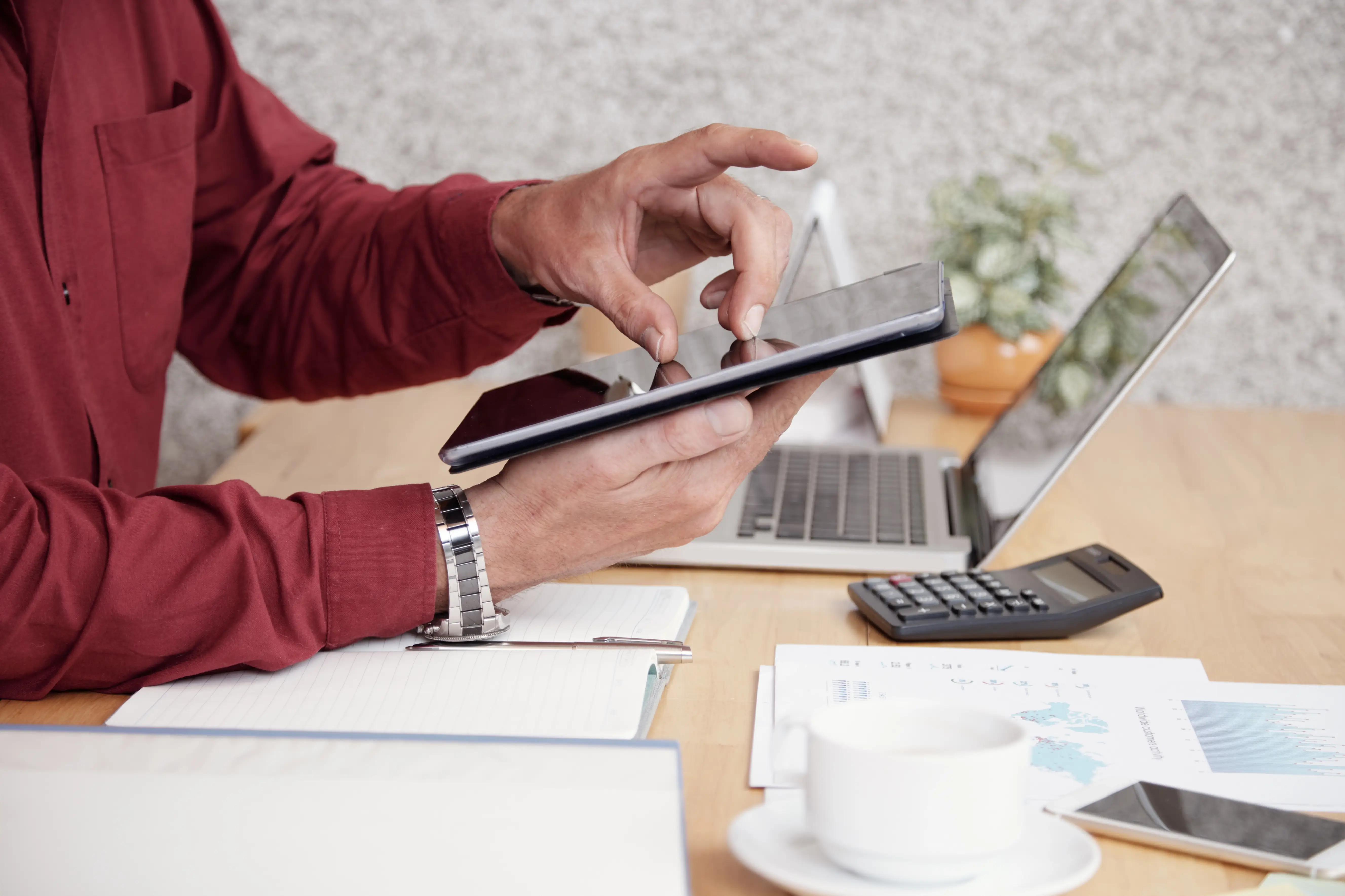 Homeowner reviewing monthly rental revenue and expense reports on a tablet