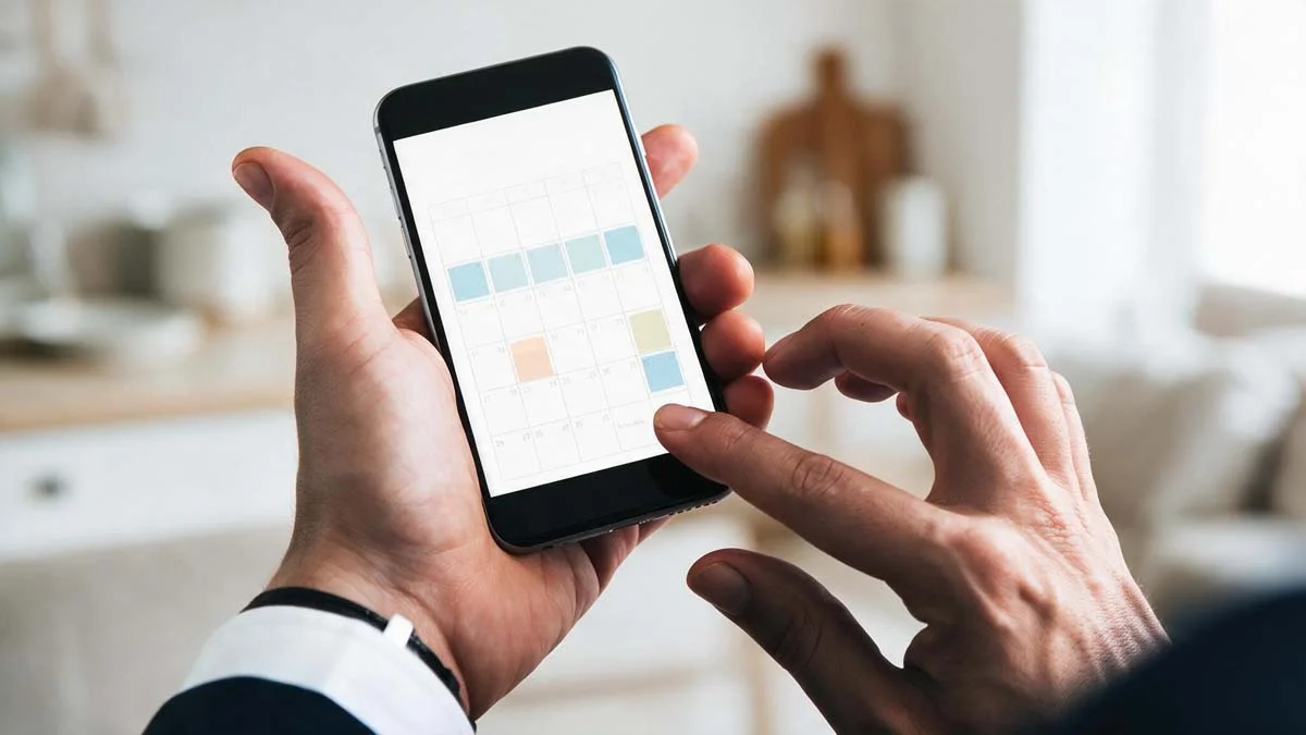 Property manager checking a vacation rental booking calendar on a smartphone