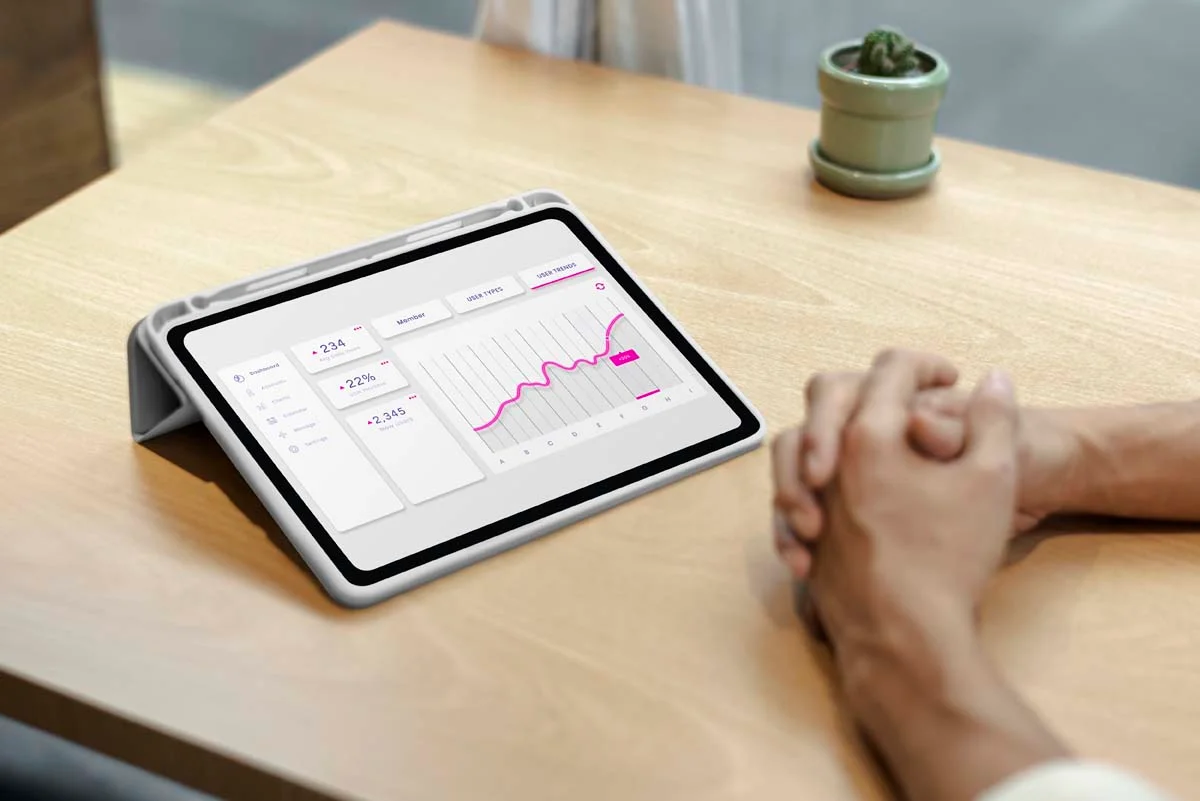 Tablet showing upward revenue growth and dynamic pricing data