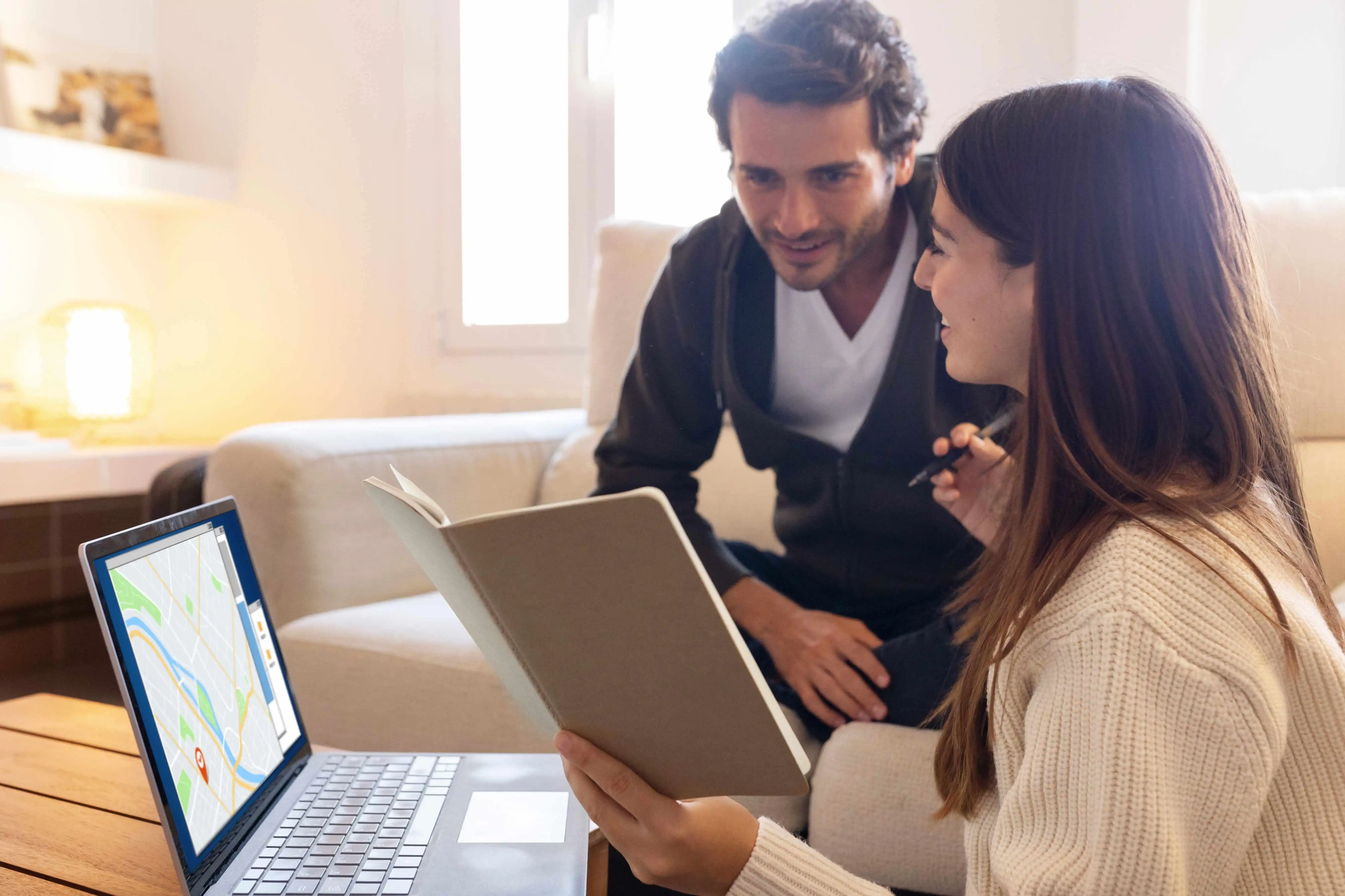 Property owners reviewing local zoning maps and rental regulations on a laptop