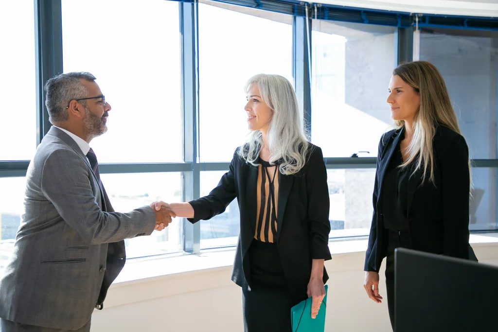 Business partners sealing a deal with a handshake during a successful corporate meeting.