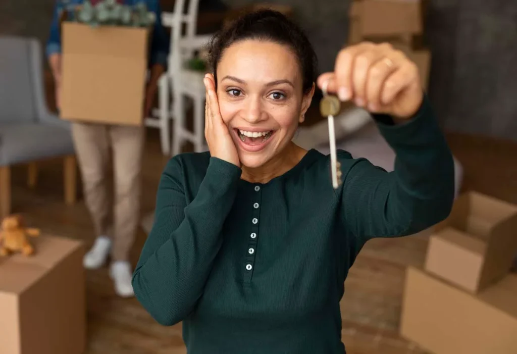 Happy property owner holding keys in a professionally managed rental home