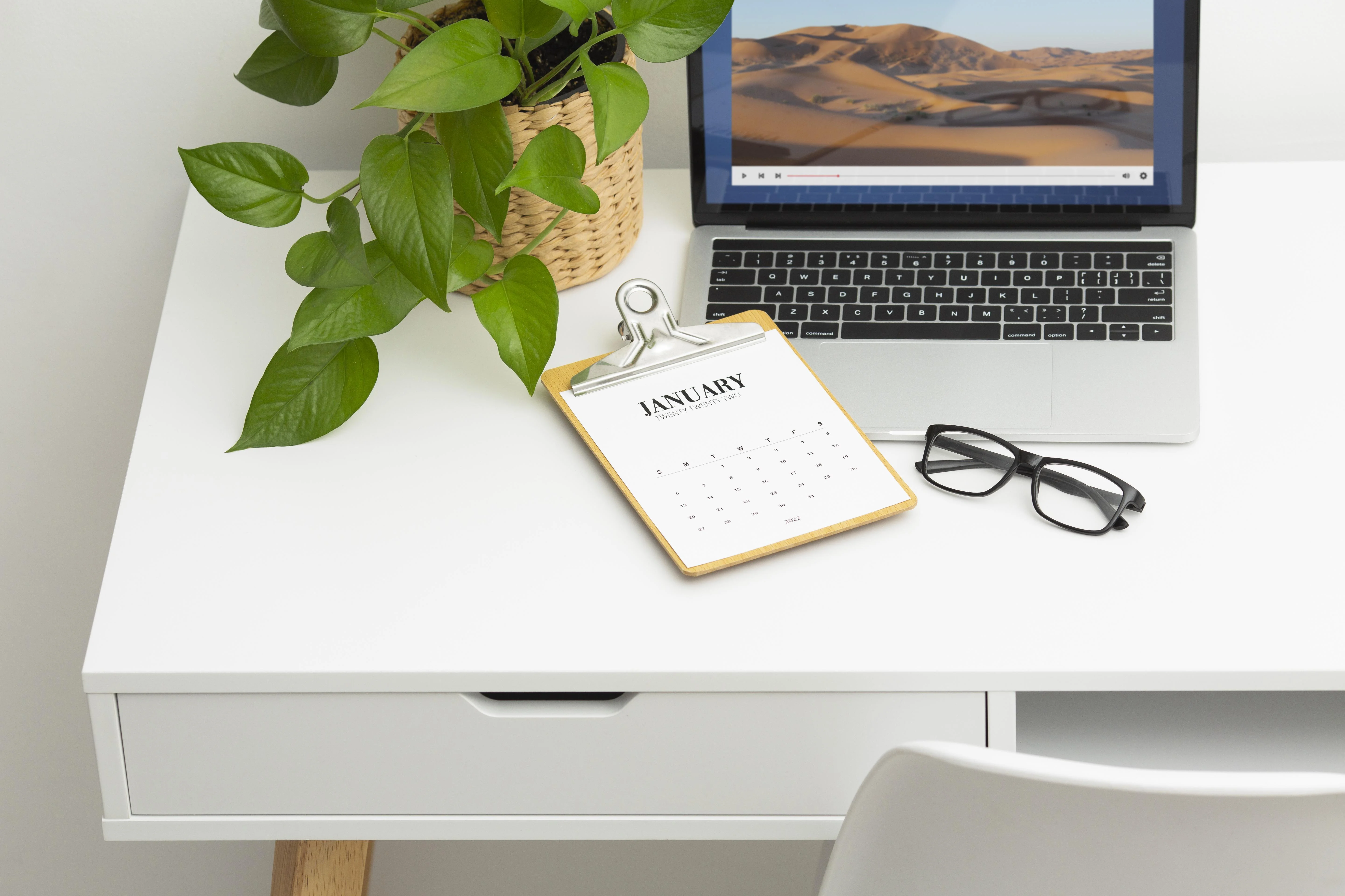 Laptop displaying rental schedules on a clean desk workspace