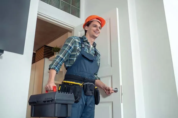 Maintenance technician performing property care and repair work in a home