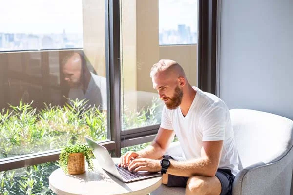 Person editing listing photos and property descriptions on a laptop