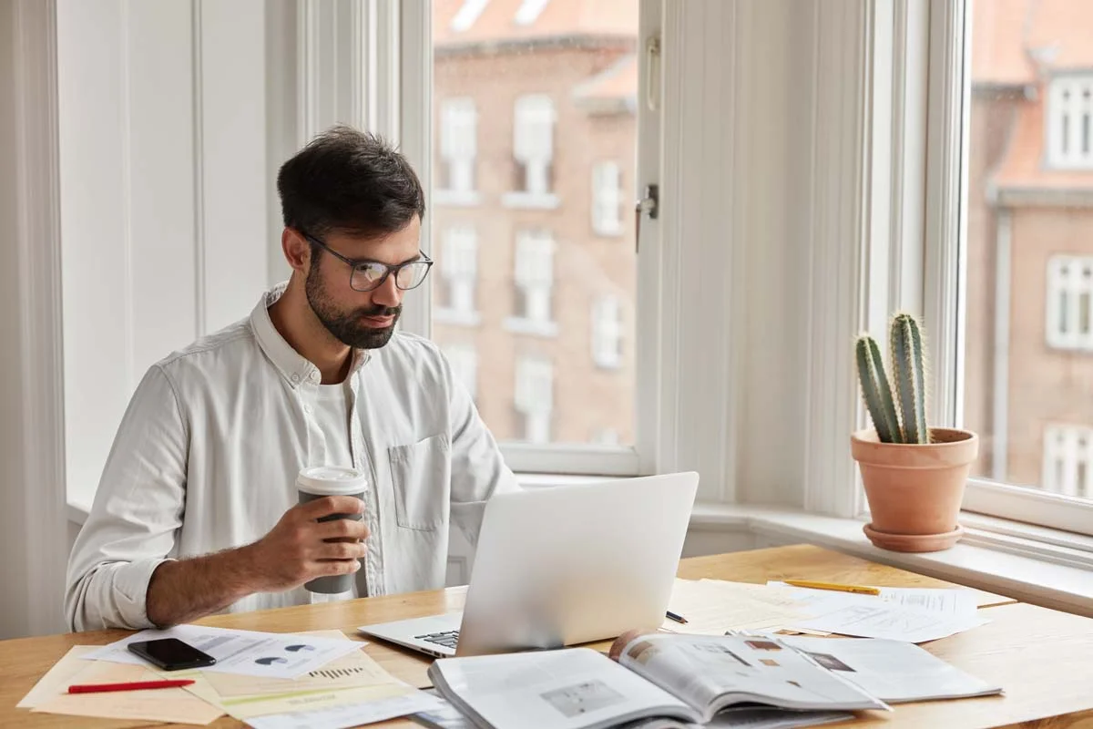 Property owner reviewing calendar bookings and market data charts on a laptop screen