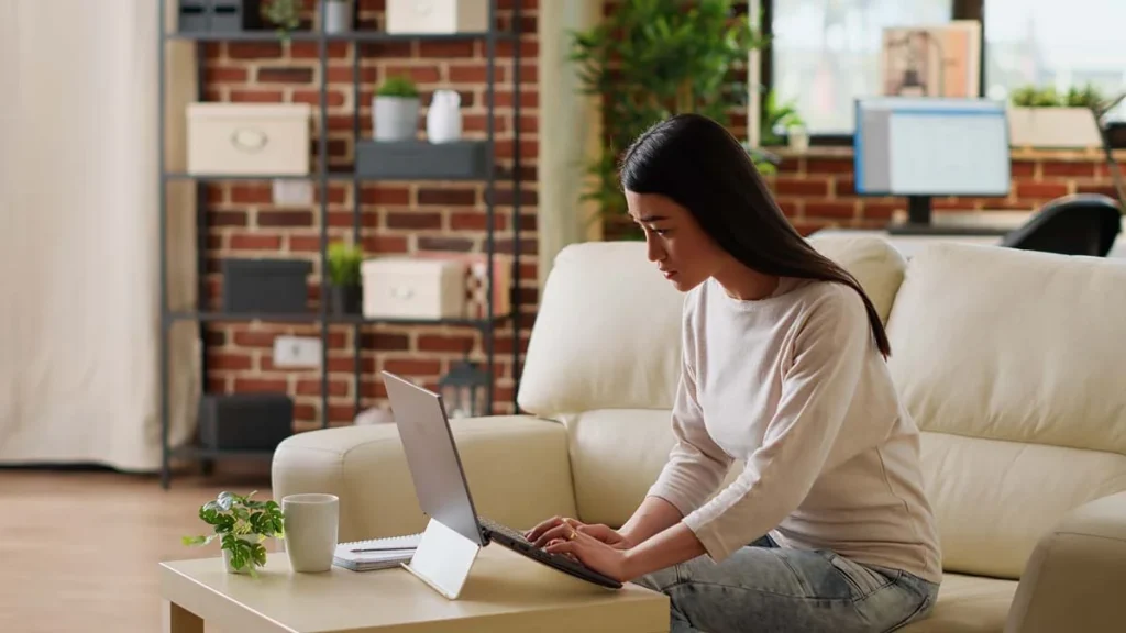 Property owner reviewing short-term rental management options on a laptop to submit their property information form