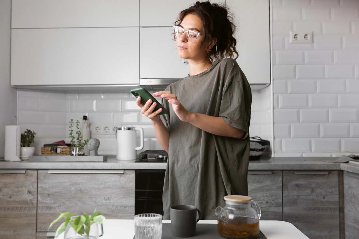 Guest using a smartphone to communicate next to an emergency instruction sheet